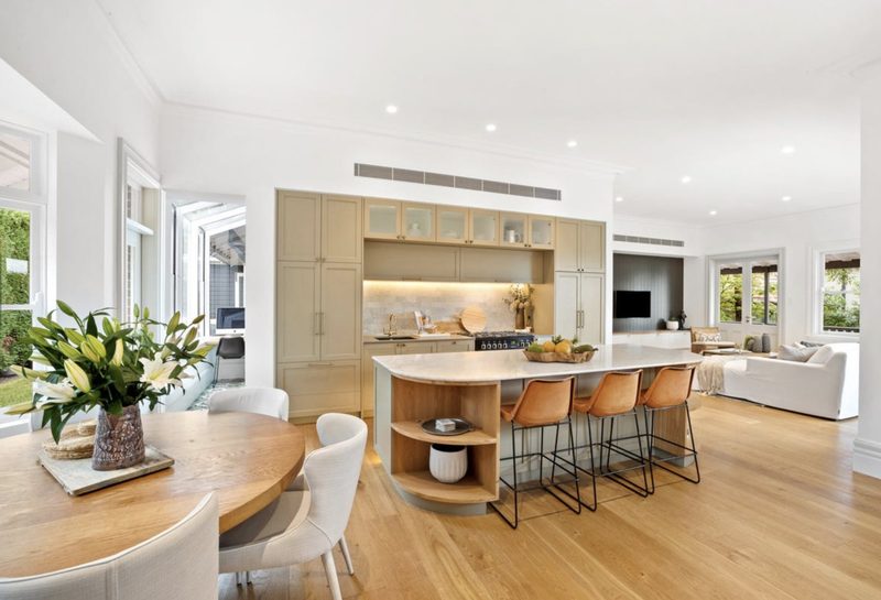 Open-plan kitchen, dining and living with timber joinery and a curved island bench, Mosman